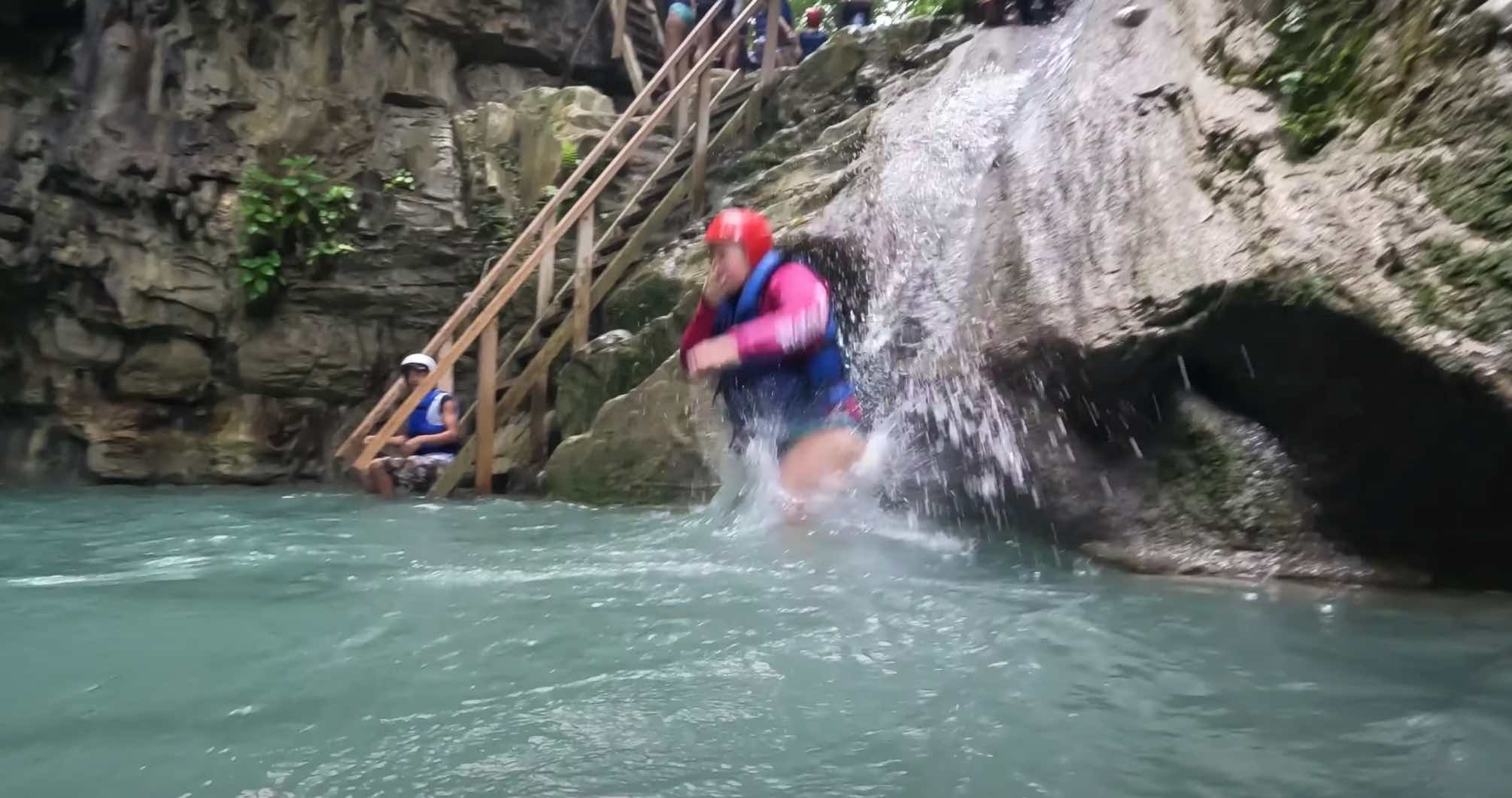 A tourist jumps into the water