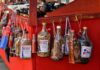 Dominican Mama Juana bottles in a street stand.