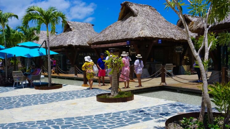 Tourists walk by the Taino bay shops