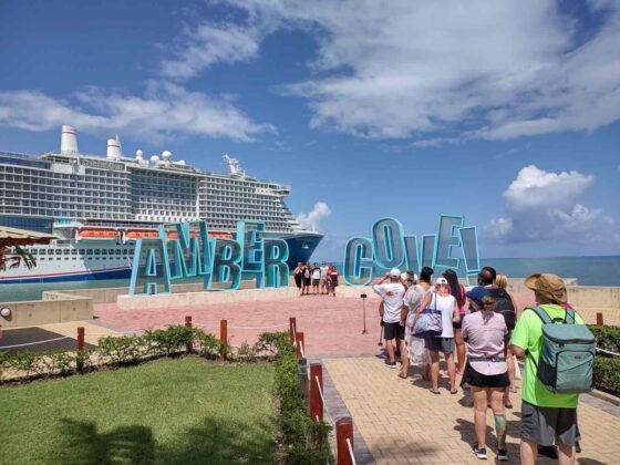 Cruise passengers flock to the photo op sign at Amber Cove